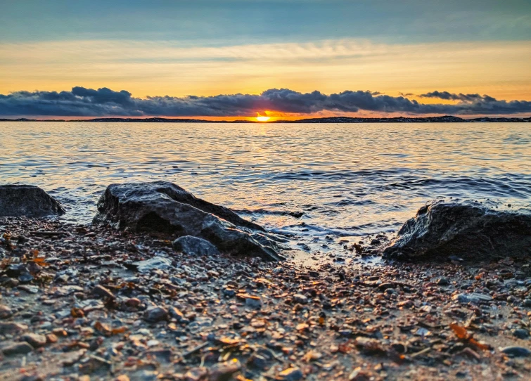 a po taken from a beach at sunset