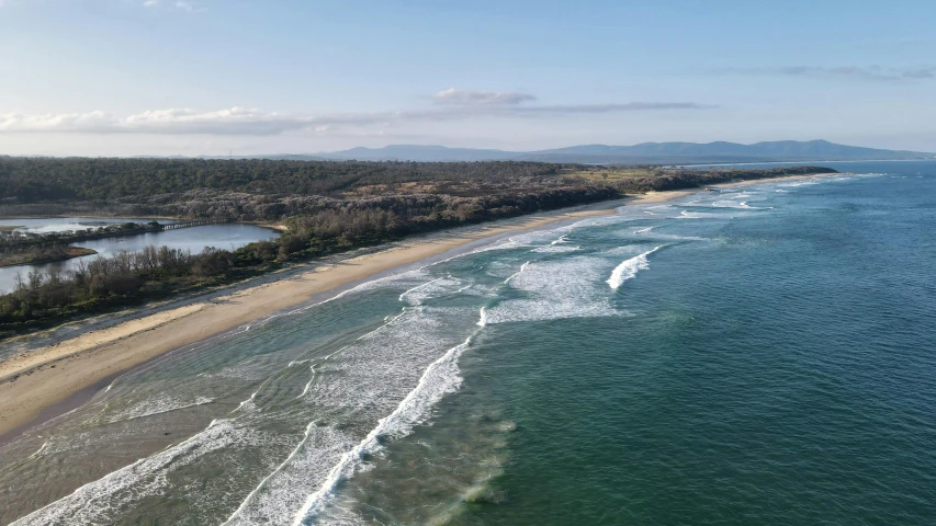 a body of water with some waves and shore