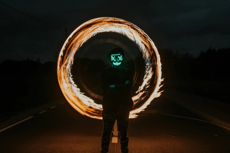 a person standing in the middle of a street holding fire