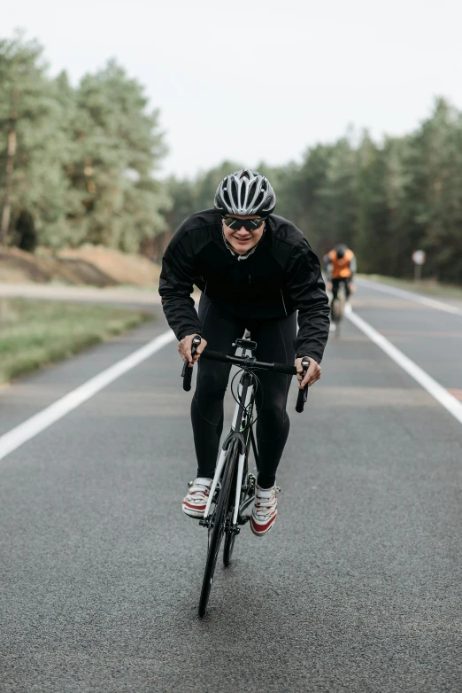 a cyclist rides his bicycle on the open road