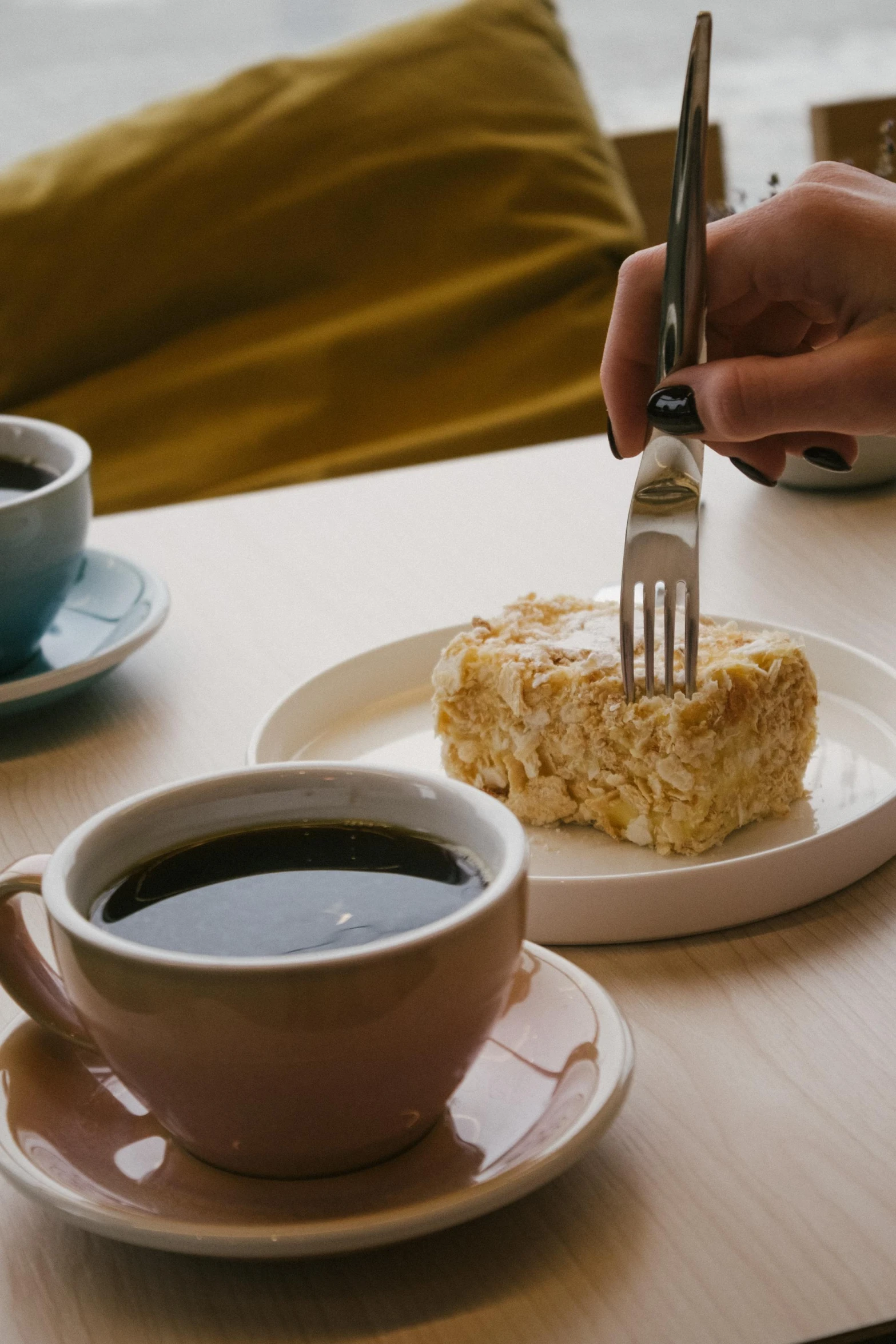 someone using fork and knife to cut a piece of food