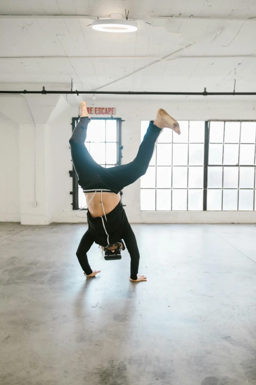 an image of a woman doing a handstand