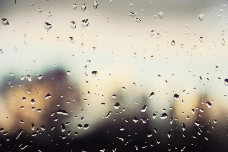 rain drops falling on glass to the building across from it