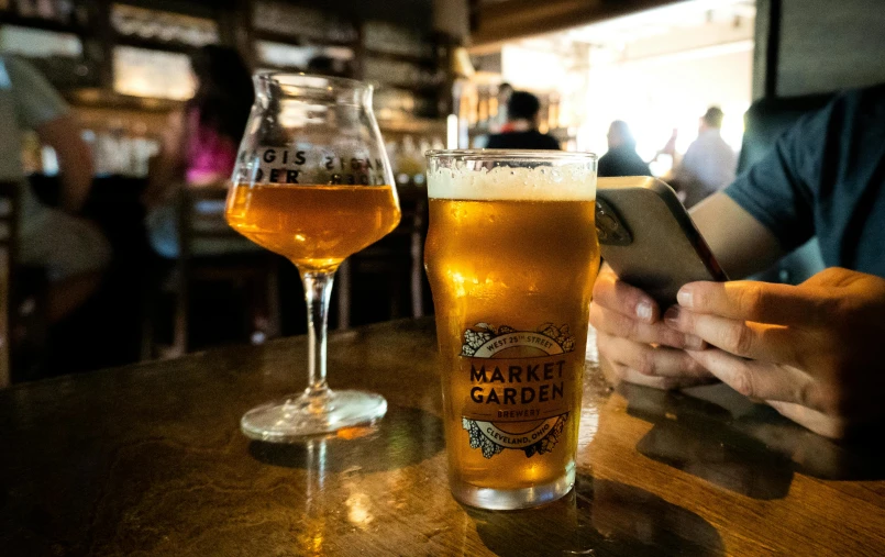 a man is sitting at a table with a beer