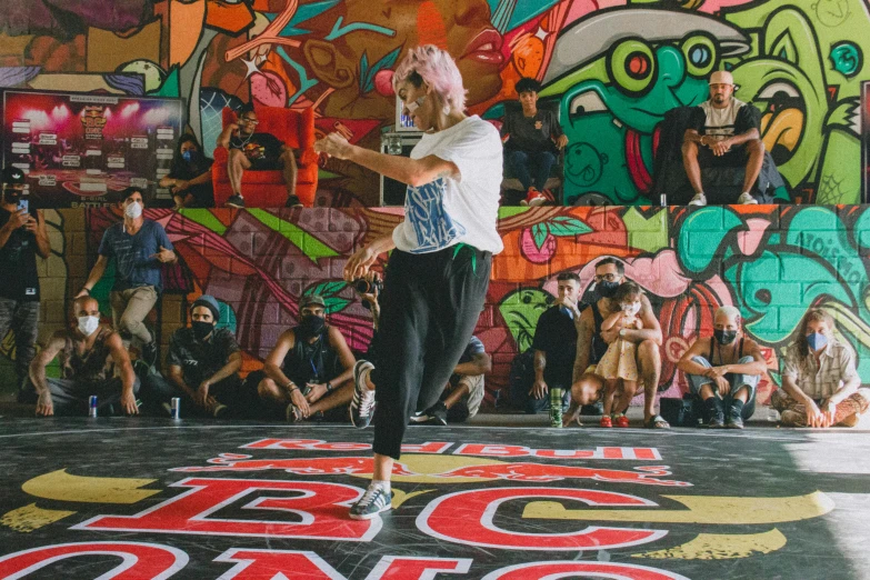 a man standing on top of a skateboard on a stage