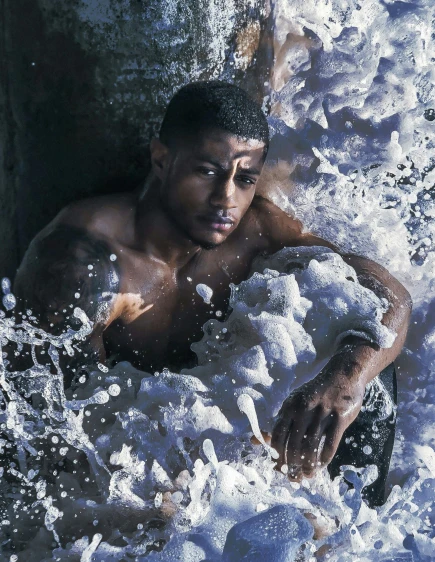 a man in white water surrounded by foam