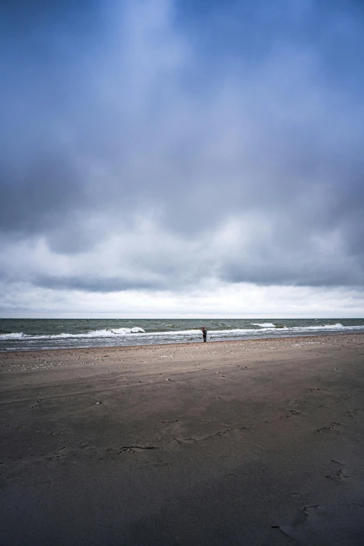 a person standing in the ocean watching soing