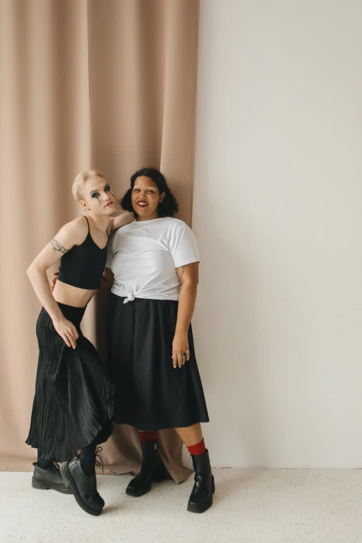 two woman dressed in costumes pose for a po