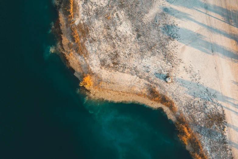 an aerial view of the water in the snow