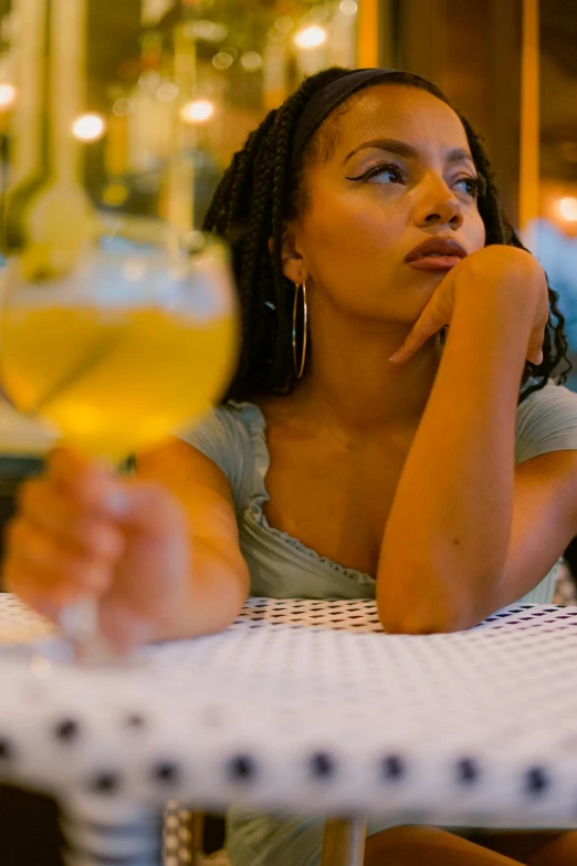 a woman is looking at her drink from the bar