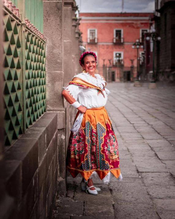 a woman posing in a traditional mexican outfit