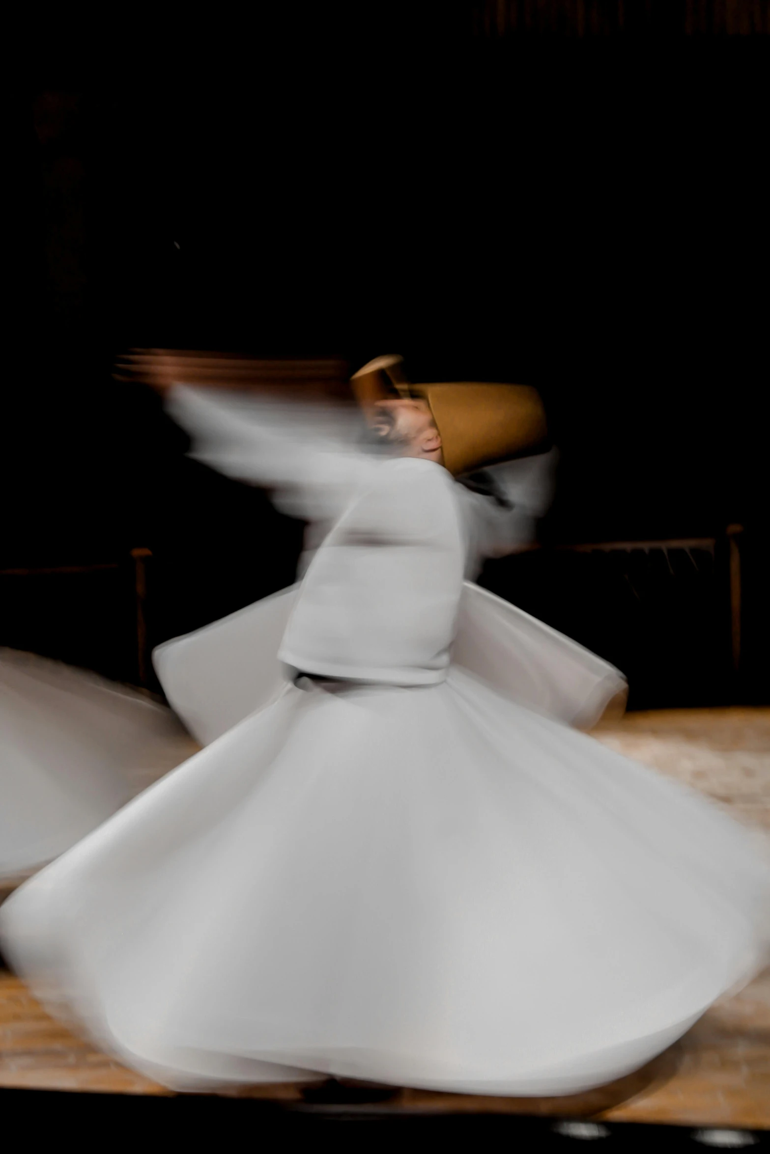 a woman is wearing white while she is doing some dance