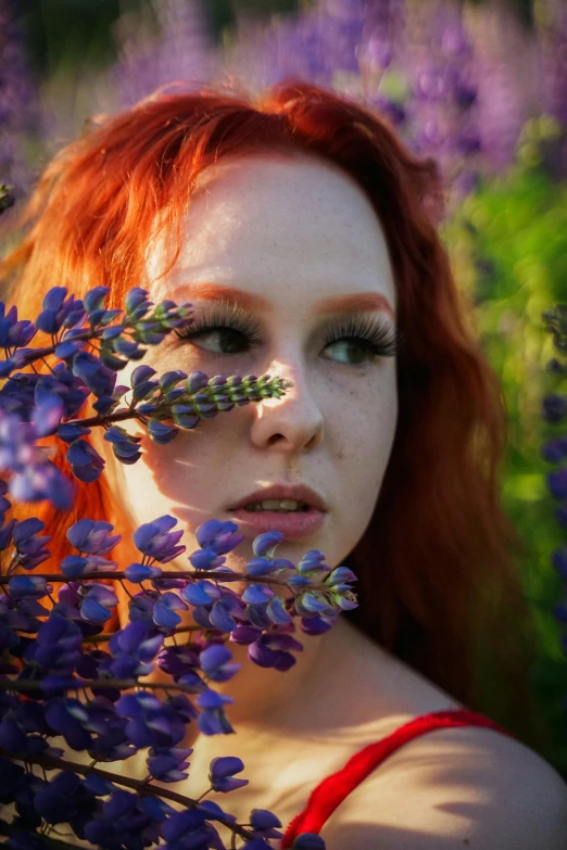 a girl with red hair and flowers in her face