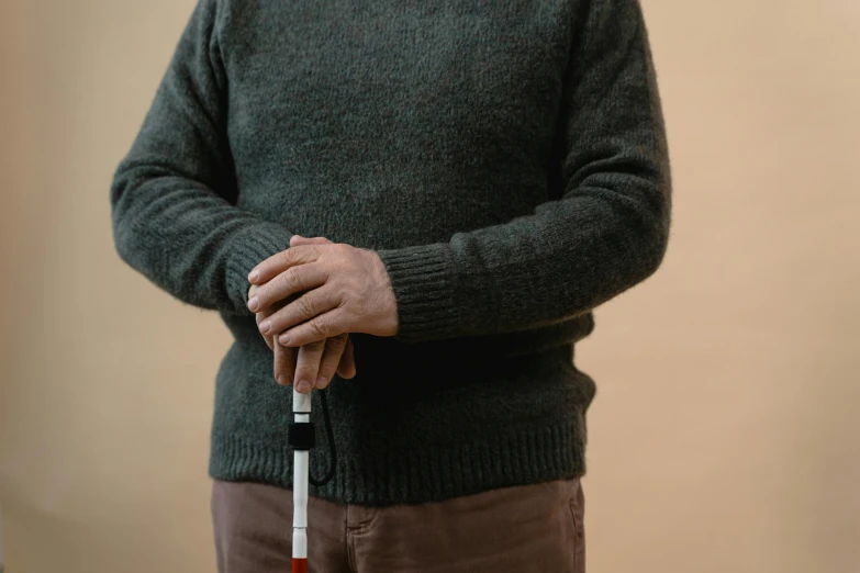 older gentleman with walking stick and green sweater