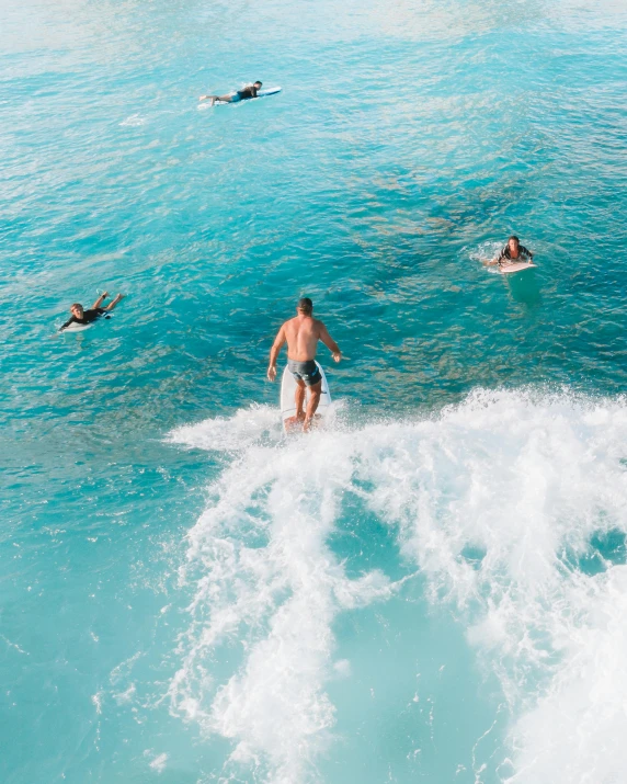 a man riding a wave on a surfboard in the ocean