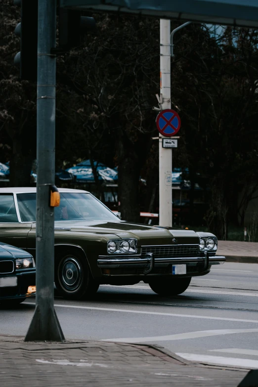 a couple of cars that are parked on a road