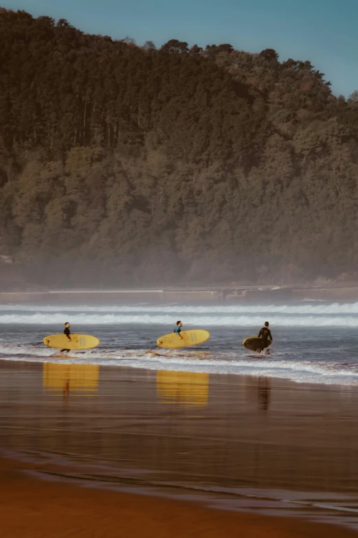 three people are on surf boards in the ocean