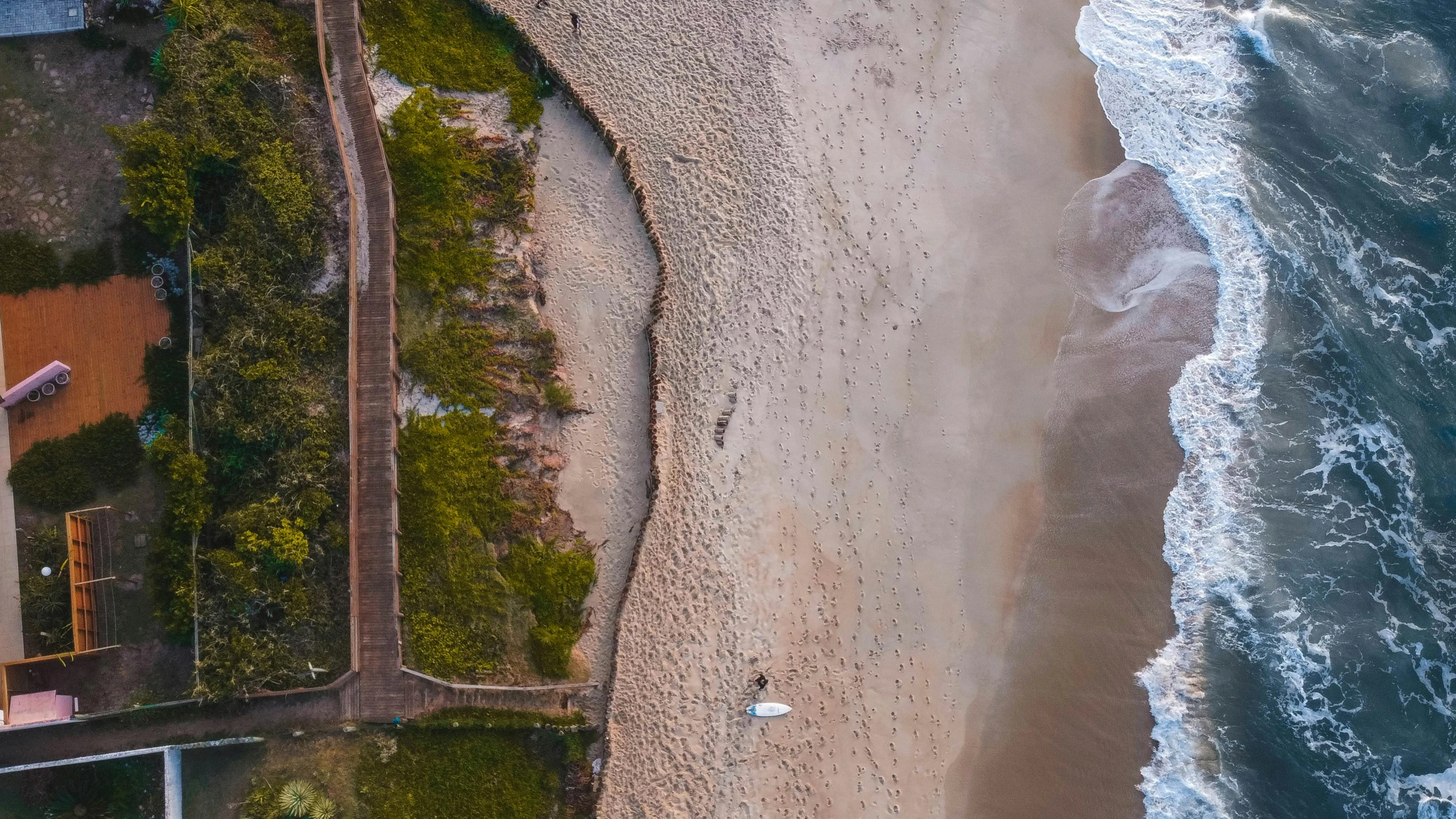 an aerial s of the beach in front of an apartment complex