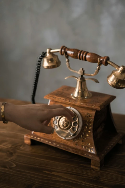 an antique telephone on top of a wooden desk