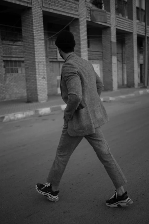 a man in a suit walking down the street