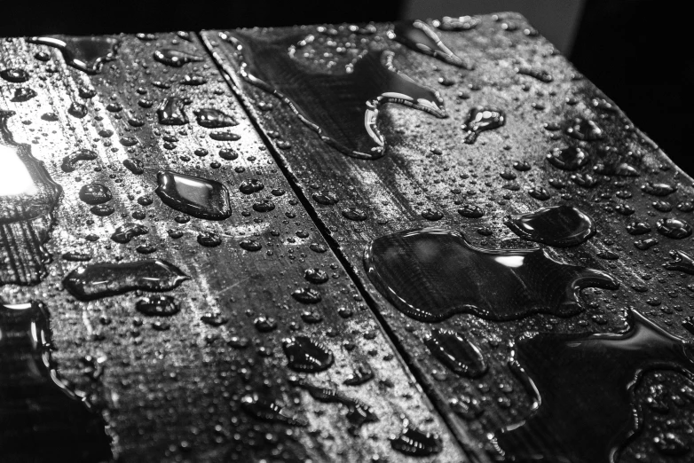 water droplets are on a wooden surface