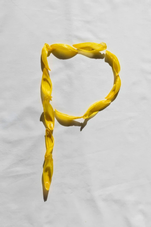 a yellow string of food with some sort of knot