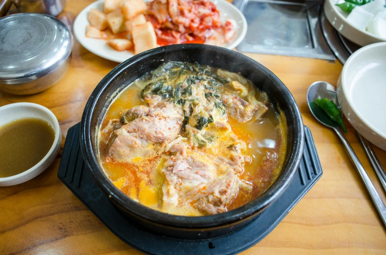 food in a dish with a spoon on a table