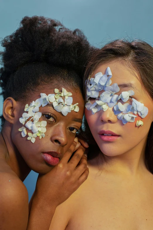 two women with painted faces and erflies on their cheeks