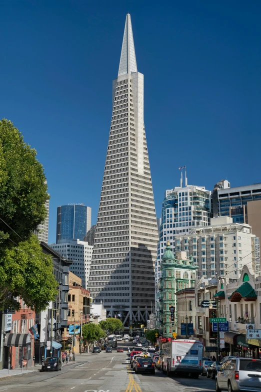 a very tall tower with cars on the street below