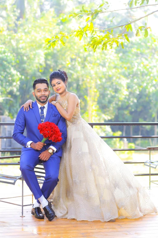 a newly married couple posing in front of some trees