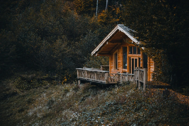 a small wooden house with wooden balconies in front of it