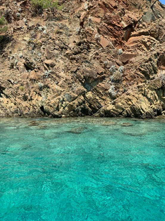 the water is clear and blue and some rocks