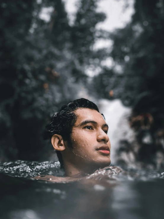 a man swimming and looking off into the distance