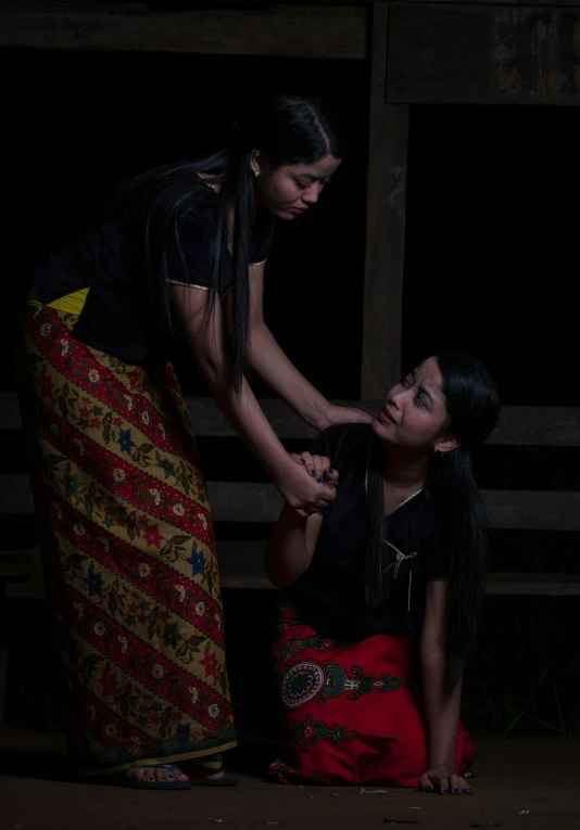 a woman is helping another woman to use her hand