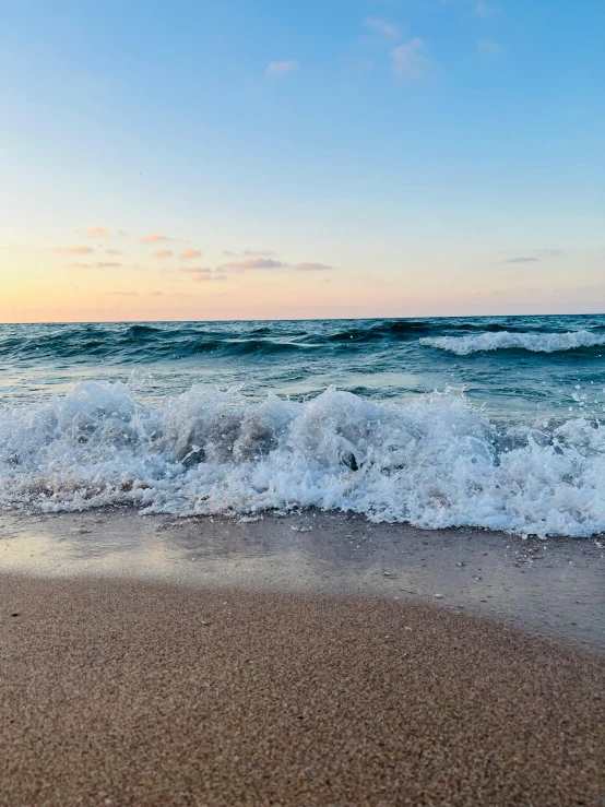 a large body of water next to a sandy beach