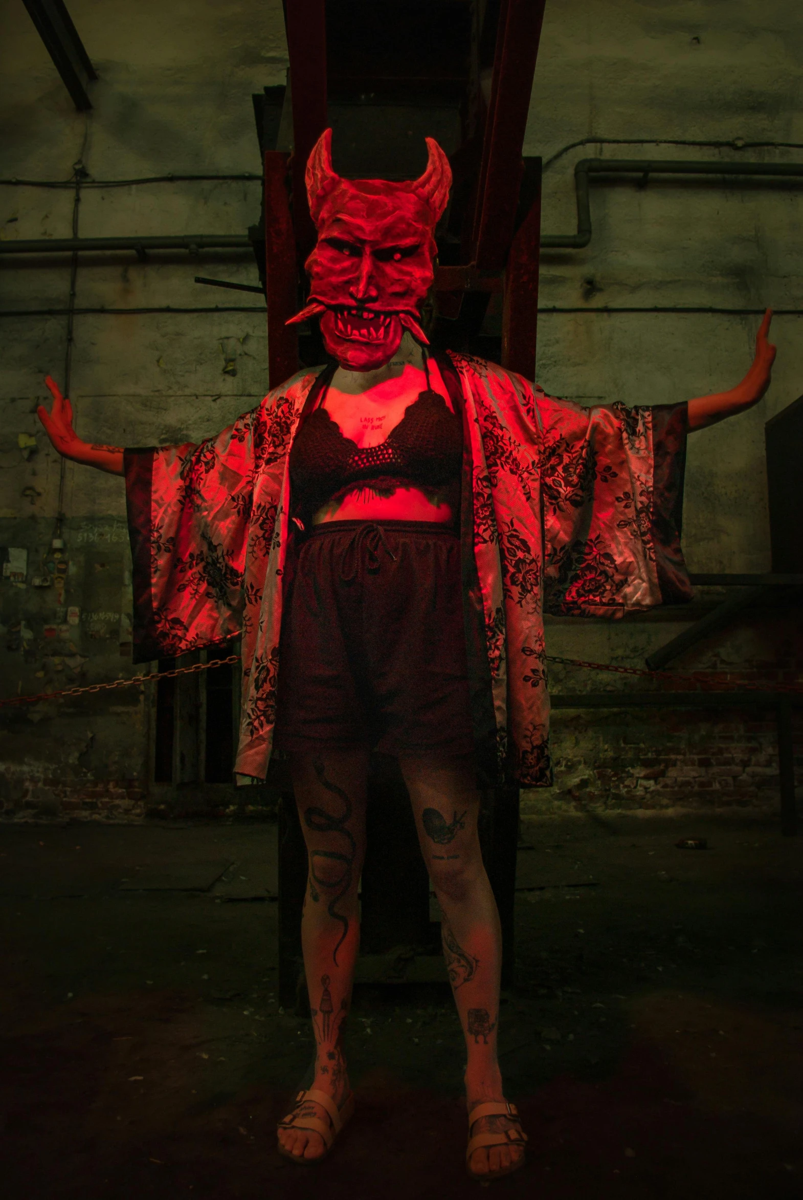 a woman dressed as devil standing by herself