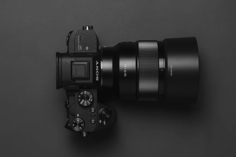 a lens attached to a camera body against a dark background