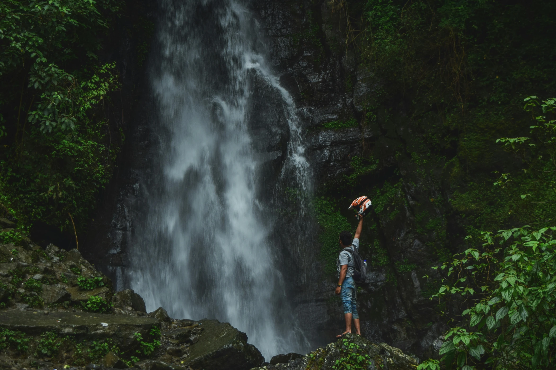 a person standing at the edge of a waterfall