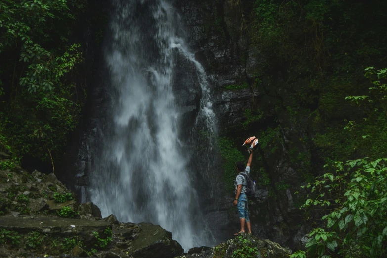 a person standing at the edge of a waterfall