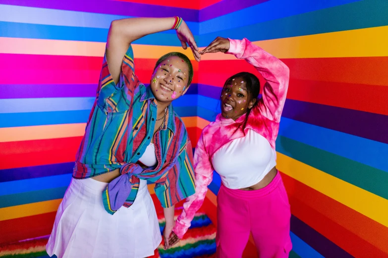 two women are posing for a po with an artistic background