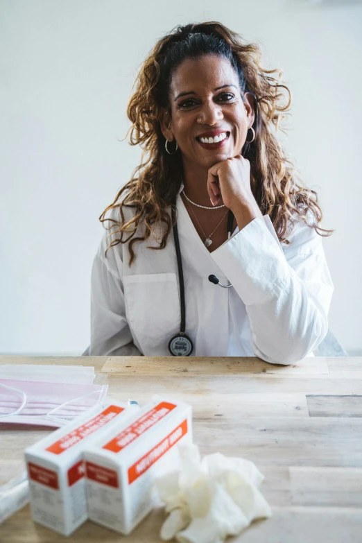 a smiling woman next to an open box of toilet paper