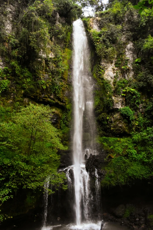 a beautiful waterfall on the side of a mountain