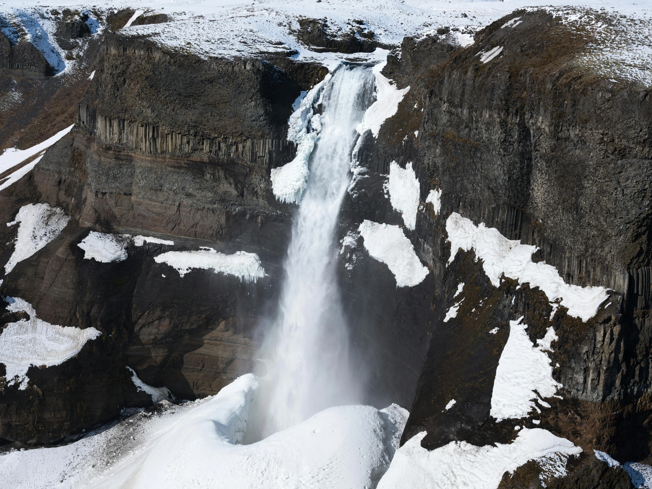 the waterfalls of a snowy mountain can be seen here