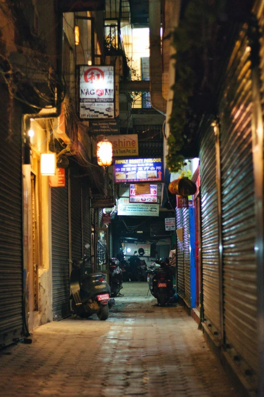 an alley way with a small motorcycle parked on it