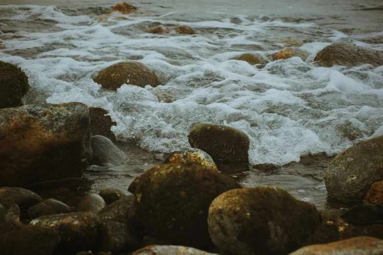 waves lapping into rocky shore with rocks