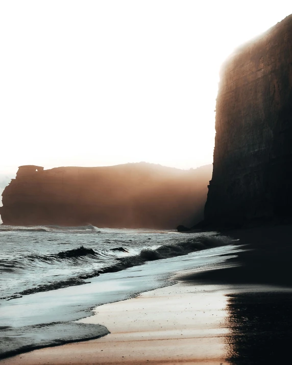 a foggy day along the coast at sunset