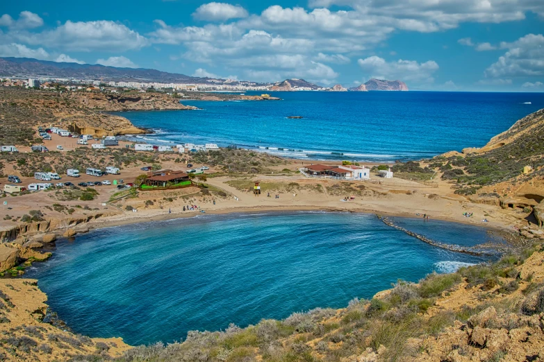 a cove is near the coast and surrounded by scrubby land