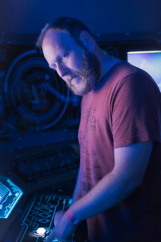 a man who is operating a laptop in front of a keyboard