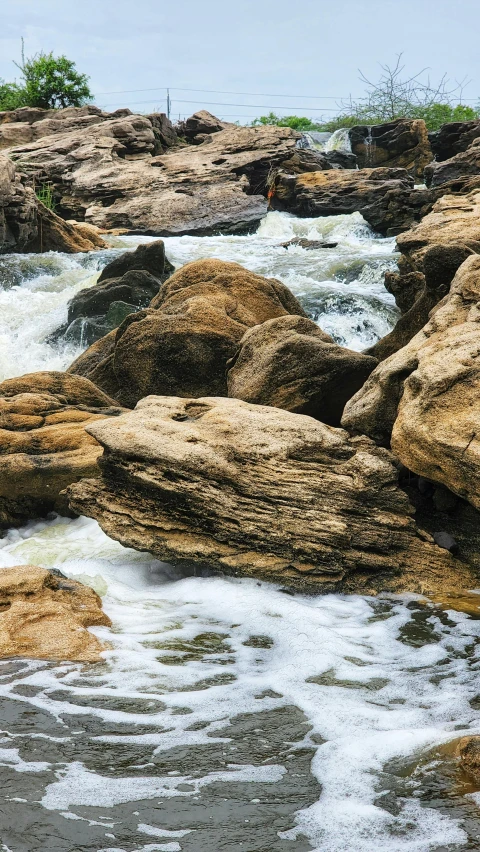 there are many large rocks with white water