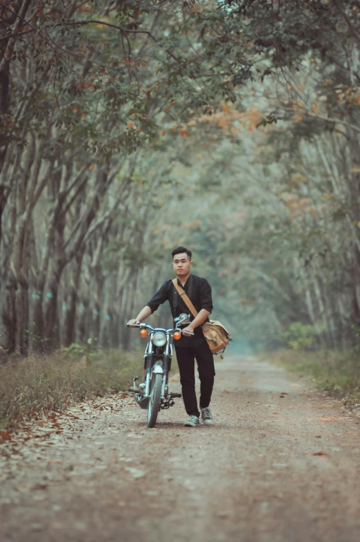 a man standing next to his motorcycle and carrying a basket